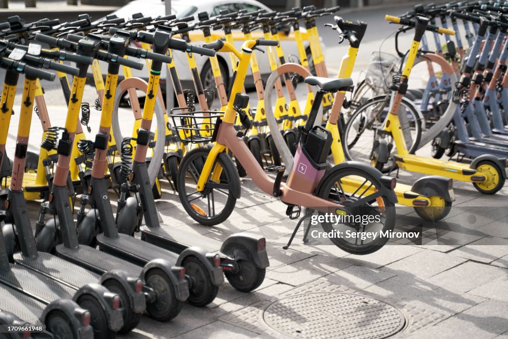 Electric transport on city street. Scooters and electric bicycles