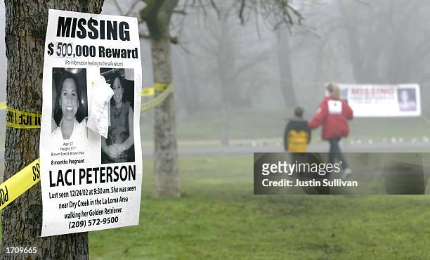 Missing person's poster offering a half-million dollar reward for the safe return of Laci Peterson is displayed on a tree at the East La Loma Park...