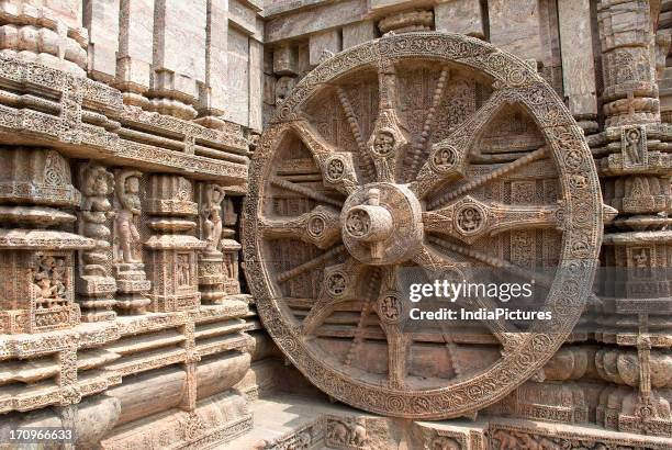 Chariot wheel and stone sculptures at Konark Sun Temple complex, Konark, Puri, Orissa, India.
