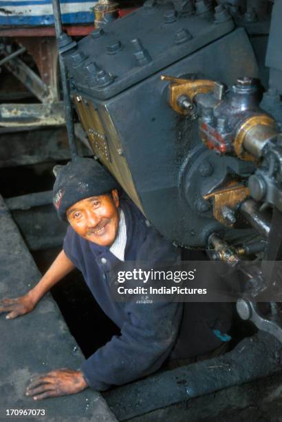 Engine driver of the steam locomotives of Darjeeling Himalayan railway at the railway workshop at Darjeeling railway Station, Darjeeling, West...