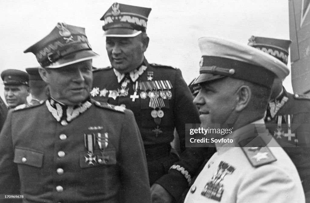 Marshals georgy zhukov and rokossovsky receive highest awards from the polish military, marshal m, rola-zymierski, commander-in-chief of the polish army, zhukov, and colonel-general s, poplawski at the warsaw aerodrome, 1945,world war 2.