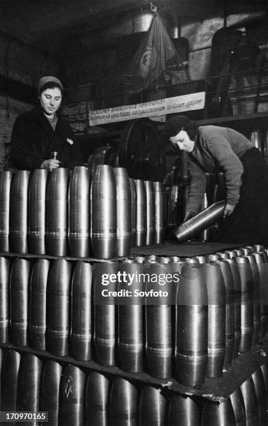 Civilian women involved in the production of artillery shells at a munitions factory in moscow during world war 2, march 1942.