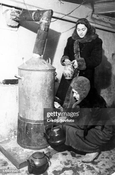 Leningrad blockade, women getting hot water in 1942.