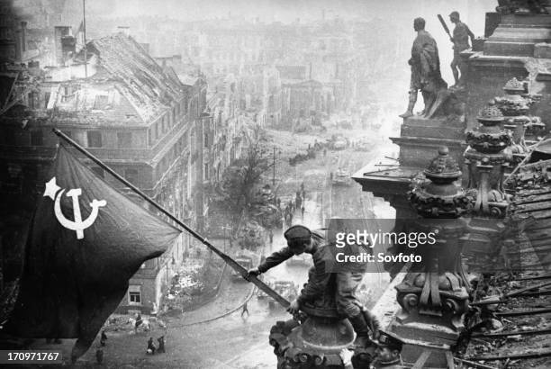 Red army soldiers raising the soviet flag over the reichstag in berlin, germany, april 30 photo taken by vladimir grebnev.