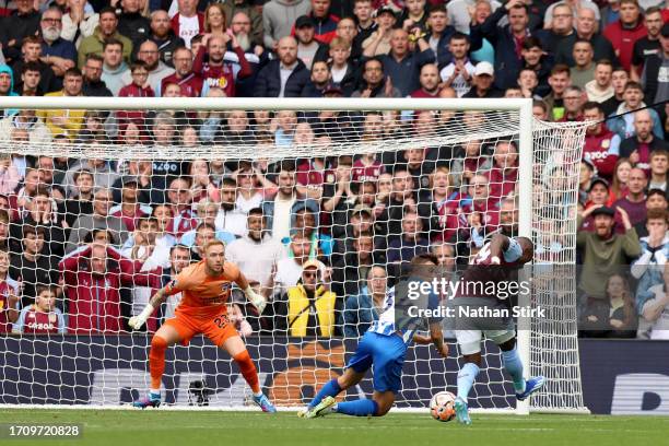 Moussa Diaby of Aston Villa takes a shot which is deflected in by Pervis Estupinan of Brighton & Hove Albion to score an own-goal during the Premier...