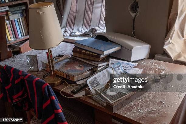 Shattered glass lies with the books on the desk in an apartment after the rocket attack hit at the intersection of Teatralna and Sadova street in...