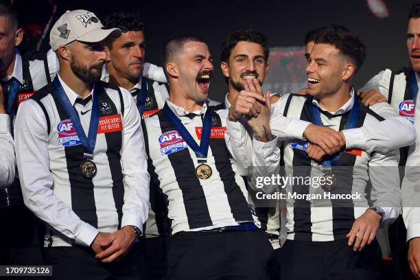 Steele Sidebottom, Scott Pendlebury, Oleg Markov, Josh Daicos, Nick Daicos and Jamie Elliott of the Magpies celebrate on stage during celebrations...