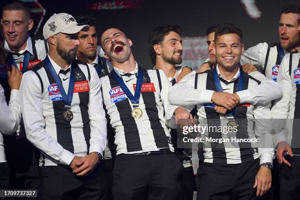 Steele Sidebottom, Scott Pendlebury, Oleg Markov, Josh Daicos, Nick Daicos and Jamie Elliott of the Magpies celebrate on stage during celebrations...