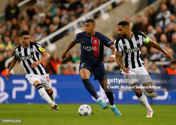 Kylian Mbappe of Paris Saint-Germain, Miguel Almiron of Newcastle United and Jamaal Lascelles of Newcastle United in action during the UEFA Champions...