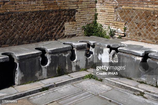 Ostia Antica. Latrine at the Domus of Triclini, headquarters of the guild of builders. 2nd century AD. Near Rome.