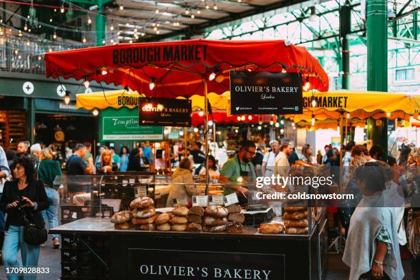 people browsing food stalls at borough market, london, uk - borough market stock pictures, royalty-free photos & images