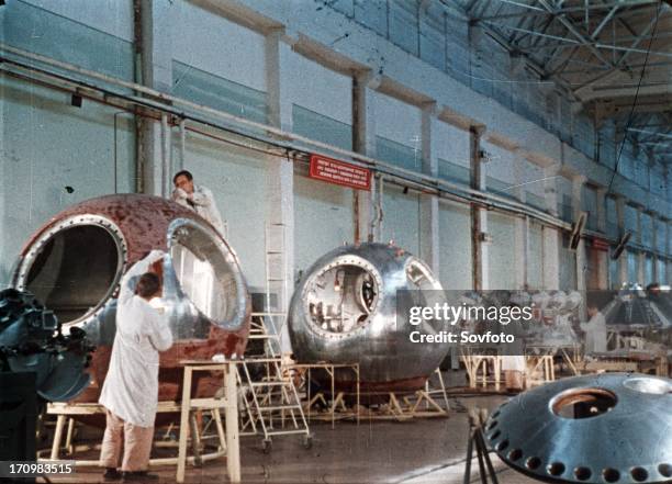 Work being done on the vostok 1 capsule in preparation for gagarin's historic flight this is a still from a soviet film about the space program.