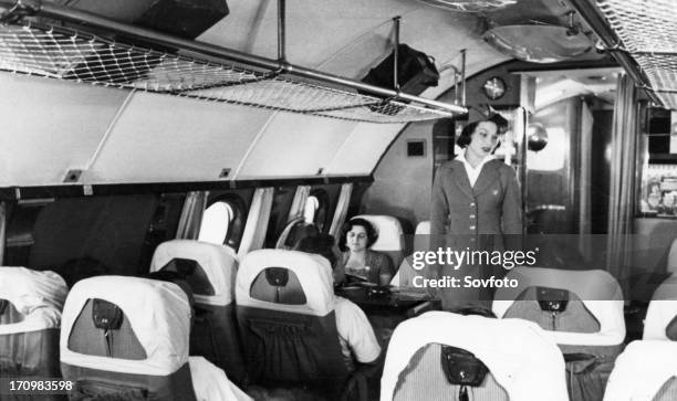 Stewardess and passengers aboard a tu-114 airliner , 1959.