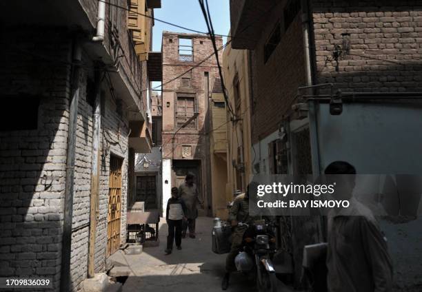 Local residents are seen in alleyways in front of a 200-year old house undergoing ownership disputes between heirs, residents, and the local...