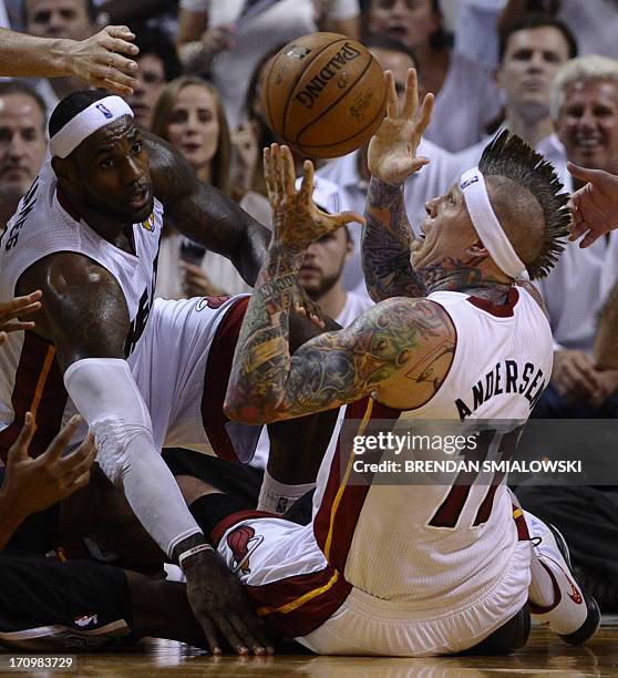 Chris Andresen and LeBron James of the Miami Heat vie for the ball against the San Antonio Spurs during the first half in Game 7 of the NBA Finals at...