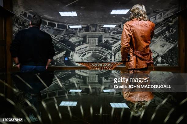 Visitors look at an old aerial photograph of Tempelhof airport during the "100 Years - 100 hours" programme to celebrate Berlin's Tempelhof airport's...