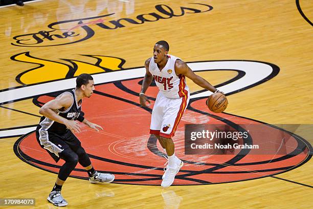 Mario Chalmers of the Miami Heat advances the ball against Danny Green of the San Antonio Spurs during Game Seven of the 2013 NBA Finals on June 20,...