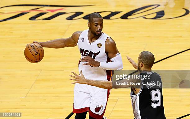 Dwyane Wade of the Miami Heat with the ball against Tony Parker of the San Antonio Spurs in the third quarter during Game Seven of the 2013 NBA...