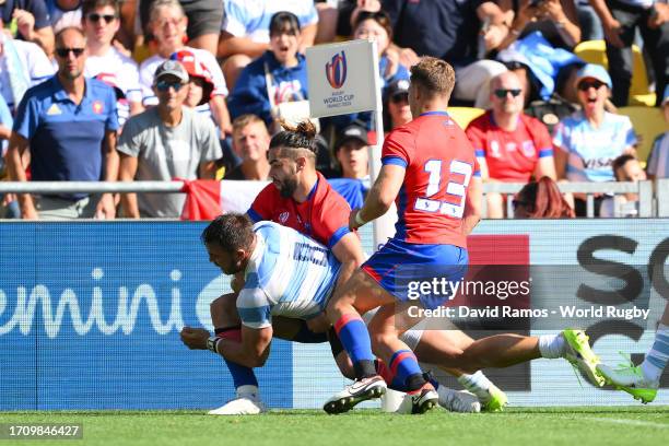 Facundo Isa of Argentina is tackled by Inaki Ayarza and Domingo Saavedra of Chile during the Rugby World Cup France 2023 match between Argentina and...