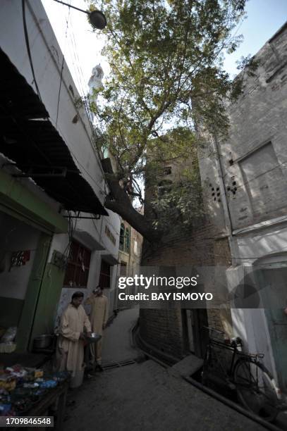 Vendor tends to his stall beside an alleyway in the old town section of Multan on March 17, 2012. Multan, one of the oldest cities in the Asian...