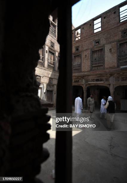 Local residents are seen in the compound of a 200-year old house undergoing ownership disputes between heirs, residents, and the local government in...