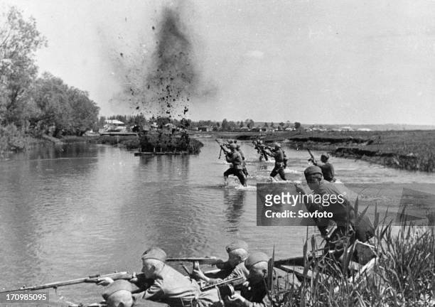 World war 2, soviet infantry crosing a river in ukraine under fire, 1943.