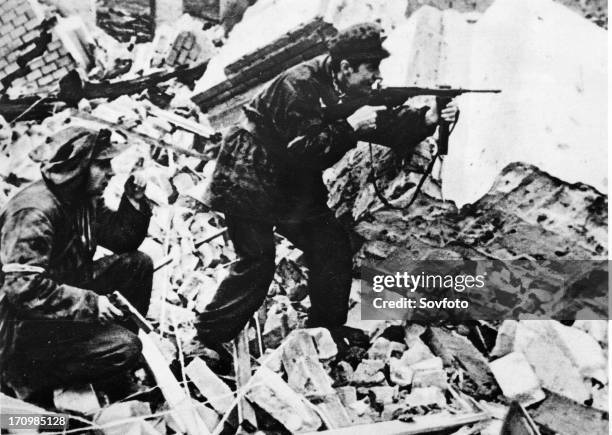 Warsaw uprising, poland world war 2, polish partisans in a fire fight with nazi soldiers on the streets of war-torn warsaw.