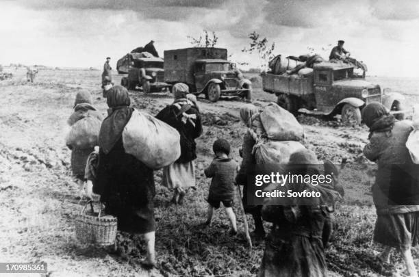 World war 2, civilian refugees walking east, past red army troops heading west to the front to counter the german advances in july 1941.