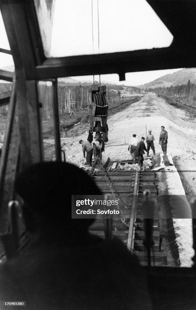 Workers laying track for the 400-mile abakan-taishet railroad through the sayan mountains in siberia, 1960.