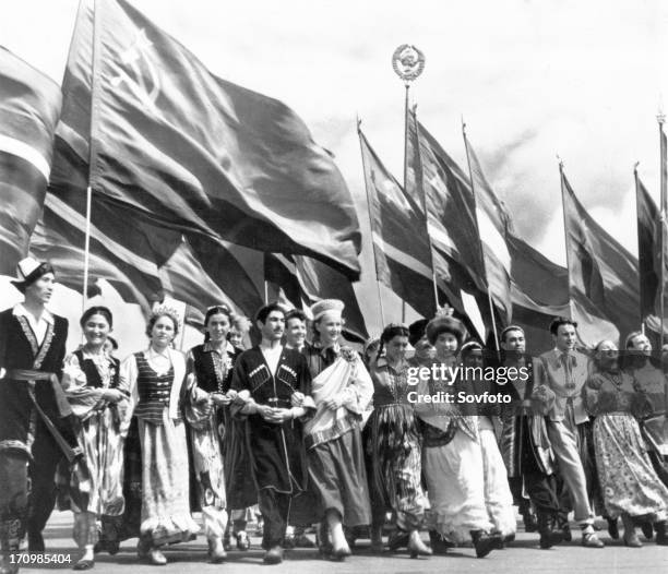 Sixth world festival of youth and students in moscow, july 28 delegates of the soviet union, representing all 15 republics, marching in lenin stadium...