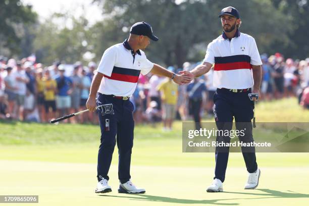 Brian Harman and Max Homa of Team United States interact on the ninth green during the Saturday afternoon fourball matches of the 2023 Ryder Cup at...