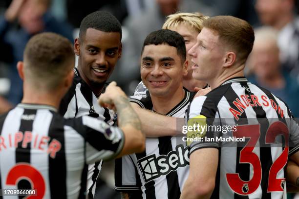 Miguel Almiron of Newcastle United celebrates with teammates after scoring the team's first goal during the Premier League match between Newcastle...