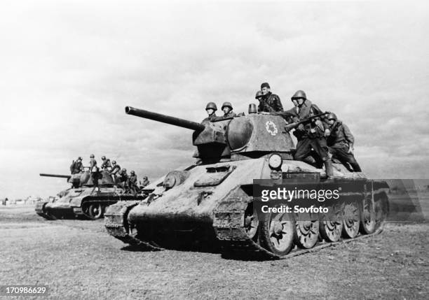 World war 2, red army soldiers heading into battle on board t-34 tanks.