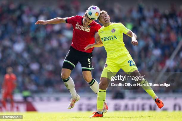 Phil Neumann of Hannover 96 competes for the ball with Lasse Guenther of SV Wehen Wiesbaden during the Second Bundesliga match between Hannover 96...