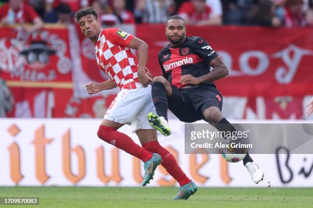 Karim Onisiwo of 1.FSV Mainz 05 is challenged by Jonathan Tah of Bayer Leverkusen during the Bundesliga match between 1. FSV Mainz 05 and Bayer 04...