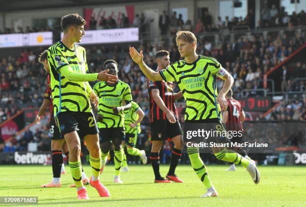 Martin Oedegaard of Arsenal celebrates with teammate Kai Havertz after scoring the team's second goal from a penalty during the Premier League match...