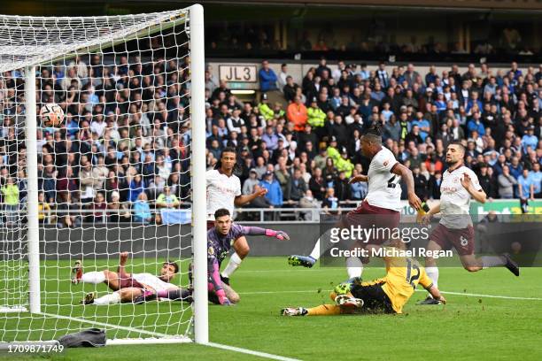 Ruben Dias of Manchester City scores an own goal, Wolverhampton Wanderers' first goal during the Premier League match between Wolverhampton Wanderers...