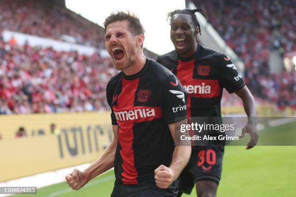 Jonas Hofmann of Bayer Leverkusen celebrates the team's third goal with teammate Jeremie Frimpong during the Bundesliga match between 1. FSV Mainz 05...