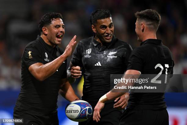 Anton Lienert-Brown of New Zealand celebrates with Rieko Ioane and Cam Roigard of New Zealand after scoring his team's fourteenth try during the...