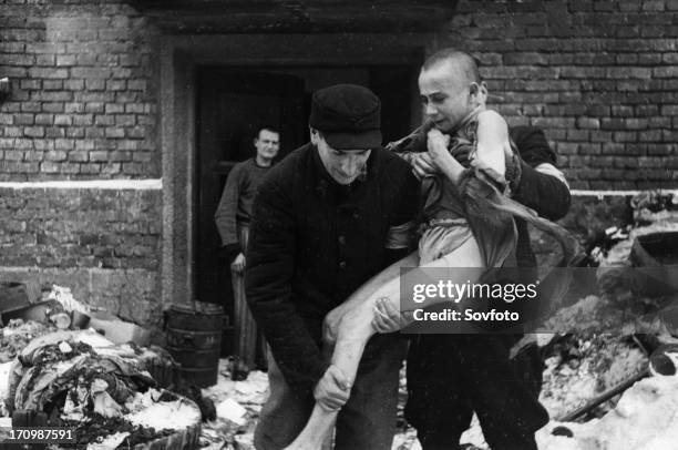 Year old Russian boy, Ivan Dudnik, who was brought to Auschwitz from his home in the Orel region by the Nazis, being rescued, he has gone insane from...