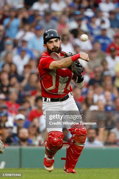 Connor Wong of the Boston Red Sox throws outa runner at first during the ninth inning against the Toronto Blue Jays at Fenway Park on August 5, 2023...