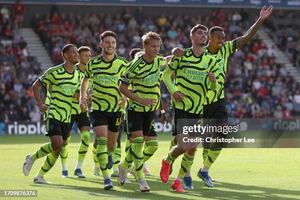 Kai Havertz of Arsenal celebrates with teammates after scoring the team's third goal from a penalty during the Premier League match between AFC...