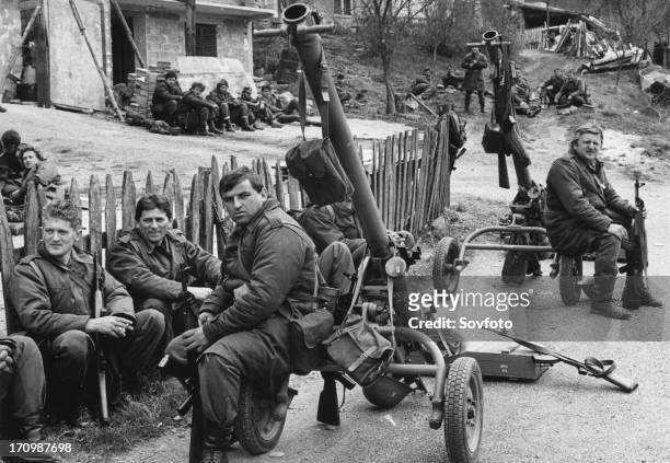 Yugoslav army reservists resting before entering bosnian town of visegrad, 170 km south of belgrade, war yugoslavia.