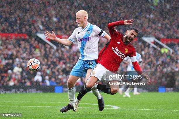 Will Hughes of Crystal Palace challenges for the ball with Bruno Fernandes of Manchester United during the Premier League match between Manchester...