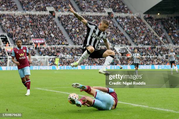 Kieran Trippier of Newcastle United jumps over Charlie Taylor of Burnley during the Premier League match between Newcastle United and Burnley FC at...