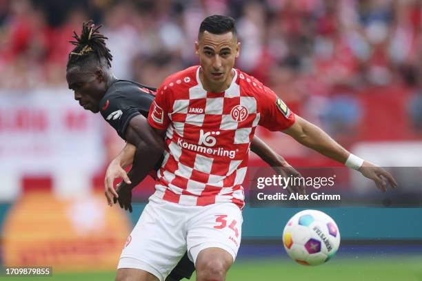 Anwar El Ghazi of Mainz is challenged by Odilon Kossounou of Bayer Leverkusen during the Bundesliga match between 1. FSV Mainz 05 and Bayer 04...