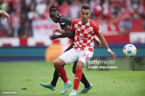 Anwar El Ghazi of Mainz is challenged by Odilon Kossounou of Bayer Leverkusen during the Bundesliga match between 1. FSV Mainz 05 and Bayer 04...