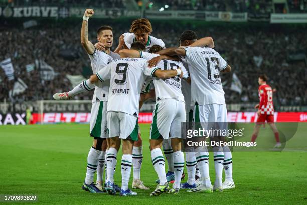 Florian Neuhaus of Borussia Moenchengladbach celebrates after scoring his team's first goal with teammates during the Bundesliga match between...