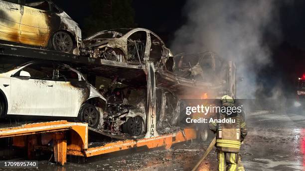 Six Tesla electric cars burn on the trailer of the moving lorry carrying them after one of them catches on fire due to unknown reasons in Istanbul,...