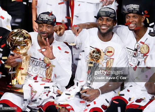 Dwyane Wade, LeBron James and Chris Bosh of the Miami Heat celebrate after defeating the San Antonio Spurs 95-88 to win Game Seven of the 2013 NBA...